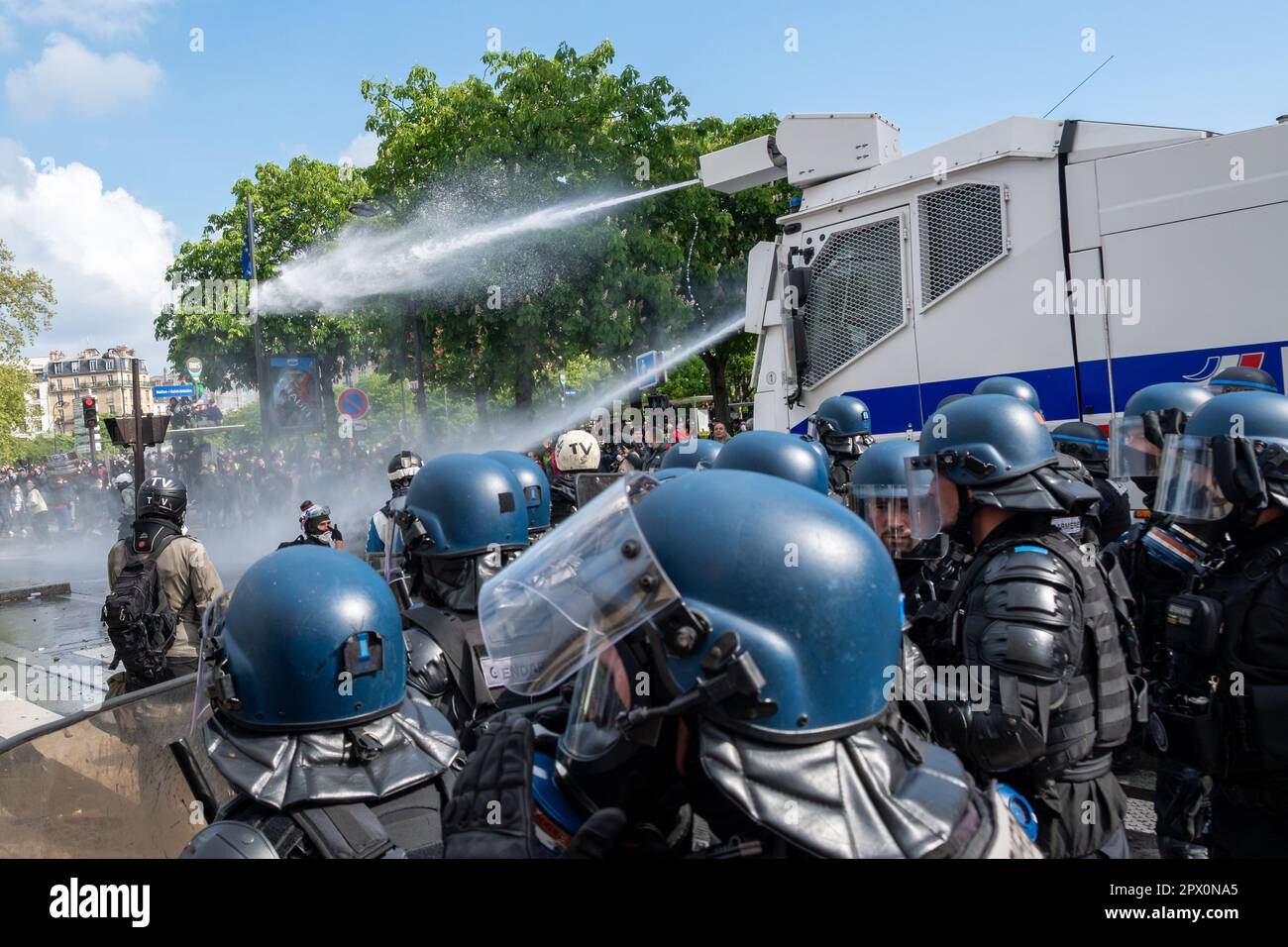 french-police-water-cannon-escorted-by-gendarmes-in-riot-gear-hosing-down-demonstrators-at-the-end-of-a-protest-against-the-retirement-reform-2PX0NA5.jpg